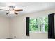 Bright bedroom with large windows dressed in dark curtains, providing natural light and a serene view at 832 Wyntuck Nw Dr, Kennesaw, GA 30152