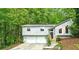 Charming split-level home nestled in a lush, green landscape with a two-car garage and inviting front entrance at 832 Wyntuck Nw Dr, Kennesaw, GA 30152