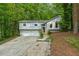 Split level home with gray siding, front lawn, driveway and two car garage at 832 Wyntuck Nw Dr, Kennesaw, GA 30152