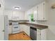 Well-lit kitchen featuring white cabinetry, granite countertops, stainless steel appliances, and a window with a wooded view at 832 Wyntuck Nw Dr, Kennesaw, GA 30152