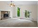 Bright living room featuring a stone fireplace and unique, geometrically-shaped windows offering wooded views at 832 Wyntuck Nw Dr, Kennesaw, GA 30152