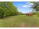 Vast backyard featuring mature trees and a small shed, ideal for outdoor activities and enjoying nature at 109 J O Simmons Path, Douglasville, GA 30134