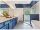 Bright and airy bathroom boasts dual sinks, a large soaking tub and a frameless glass shower at 109 J O Simmons Path, Douglasville, GA 30134