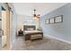 A primary bedroom offers a sliding barn door to the en suite bath, a ceiling fan and room to relax at 109 J O Simmons Path, Douglasville, GA 30134