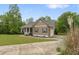 Side view of a charming home with a front porch, complemented by well-maintained landscaping and an inviting driveway at 109 J O Simmons Path, Douglasville, GA 30134