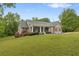 Charming home with a welcoming front porch, beautiful landscaping, and a well-manicured lawn at 109 J O Simmons Path, Douglasville, GA 30134