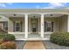 Inviting front porch with classic white columns, landscaping, and stylish front door at 109 J O Simmons Path, Douglasville, GA 30134