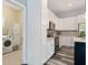 Spacious kitchen with white cabinets, stainless appliances, and adjacent laundry room at 109 J O Simmons Path, Douglasville, GA 30134
