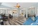 Open-concept living room featuring hardwood floors, ceiling fan, and seamless flow to kitchen at 109 J O Simmons Path, Douglasville, GA 30134