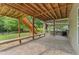 Spacious stone patio area under a raised deck featuring outdoor seating and a grill for entertaining at 109 J O Simmons Path, Douglasville, GA 30134