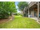Lush green backyard with well-maintained lawn and peaceful, tree-lined surroundings at 2292 W Village Junction Se Way, Smyrna, GA 30080