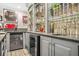 Convenient bar featuring a small refrigerator, sink, and display cabinets at 2292 W Village Junction Se Way, Smyrna, GA 30080