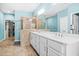 Elegant bathroom with a glass shower, double sinks, and a large mirror reflecting the closet at 2292 W Village Junction Se Way, Smyrna, GA 30080