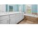 Large ensuite bath features a double sink vanity, garden tub and tile floors at 2292 W Village Junction Se Way, Smyrna, GA 30080