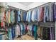 Walk-in closet filled with neatly arranged clothes on shelves and hanging rods for optimal storage at 2292 W Village Junction Se Way, Smyrna, GA 30080