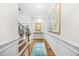 Inviting foyer with hardwood floors, decorative wall paneling, and a view of the living spaces at 2292 W Village Junction Se Way, Smyrna, GA 30080