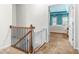 Upstairs hallway with a safety gate leading to a bedroom with blue walls at 2292 W Village Junction Se Way, Smyrna, GA 30080