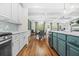 Open concept kitchen leading to dining and living area with stainless appliances, island and modern fixtures at 2292 W Village Junction Se Way, Smyrna, GA 30080