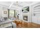 Elegant living room with coffered ceilings, a fireplace, built-in shelving, and hardwood floors at 2292 W Village Junction Se Way, Smyrna, GA 30080