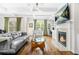 Bright living room featuring hardwood floors, fireplace, white coffered ceiling and modern furnishings at 2292 W Village Junction Se Way, Smyrna, GA 30080