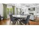 Open concept to dining area featuring a fireplace, hardwood floors, coffered ceiling and modern furnishings at 2292 W Village Junction Se Way, Smyrna, GA 30080