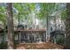 Backyard view featuring a deck and screened porch, surrounded by mature trees at 27 Sycamore Sta, Decatur, GA 30030