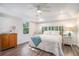 Serene bedroom with tray ceilings, wood floors, a ceiling fan, a comfortable bed, and bright, natural light at 27 Sycamore Sta, Decatur, GA 30030