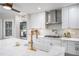Well-designed kitchen featuring white cabinetry, stainless steel appliances, a decorative backsplash, and a stylish, gold faucet at 27 Sycamore Sta, Decatur, GA 30030