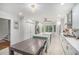 Spacious kitchen featuring a large island, white cabinets, stainless steel appliances, and stylish fixtures with a dining area at 27 Sycamore Sta, Decatur, GA 30030