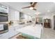 Bright kitchen featuring a large island with quartz countertop, white cabinets, stainless steel appliances, and modern fixtures at 27 Sycamore Sta, Decatur, GA 30030
