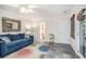 Living room with French doors, blue sofa, and decorative mirror at 27 Sycamore Sta, Decatur, GA 30030