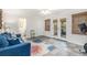 Living room with French doors, blue sofa, and an exercise bike at 27 Sycamore Sta, Decatur, GA 30030