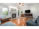 Inviting living room featuring a fireplace, hardwood floors, comfortable seating, and natural light from the windows and glass door at 27 Sycamore Sta, Decatur, GA 30030