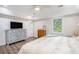 Spacious main bedroom with a dresser, natural light and wood laminate floors at 27 Sycamore Sta, Decatur, GA 30030