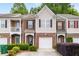 Charming townhome featuring brick accents, neutral siding, and a one-car garage at 2826 Snapfinger Mnr, Decatur, GA 30035
