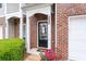 Inviting brick townhome entrance with a covered porch and well-manicured landscaping at 2826 Snapfinger Mnr, Decatur, GA 30035