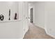 Hallway with neutral carpet and wall niche showcasing decorative art at 2826 Snapfinger Mnr, Decatur, GA 30035