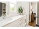 Bright bathroom with double sinks, white cabinets, marble countertops, and a view of the Bedroom at 425 Harold Ne Ave, Atlanta, GA 30307