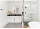 Bathroom with glass shower, black hardware, white subway tile, black granite countertop at 425 Harold Ne Ave, Atlanta, GA 30307