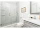 Modern bathroom featuring a tiled shower with glass door, gray vanity, and chrome fixtures at 425 Harold Ne Ave, Atlanta, GA 30307