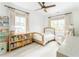 Serene bedroom with a ceiling fan, natural light, cream walls, wood floors and a bookcase at 425 Harold Ne Ave, Atlanta, GA 30307