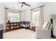 Cozy Bedroom featuring neutral decor, a crib, a comfy chair, and a bookshelf filled with colorful books at 425 Harold Ne Ave, Atlanta, GA 30307