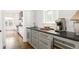 Butler pantry with grey cabinets, stone countertops, wine cooler, and luxury fixtures at 425 Harold Ne Ave, Atlanta, GA 30307