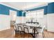 Formal dining room boasts elegant wainscoting, a modern chandelier, and hardwood flooring at 425 Harold Ne Ave, Atlanta, GA 30307