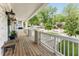 Inviting covered porch featuring wood flooring, stylish lighting, and views of the well-manicured yard at 425 Harold Ne Ave, Atlanta, GA 30307