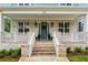 Charming brick porch with white railings and stately front door with decorative wreath at 425 Harold Ne Ave, Atlanta, GA 30307
