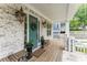 Covered porch showcasing stylish lighting fixtures, comfortable bench seating, and views of the neighborhood at 425 Harold Ne Ave, Atlanta, GA 30307