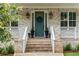 Welcoming front porch featuring a decorative wreath, stylish lighting, and elegant planters at 425 Harold Ne Ave, Atlanta, GA 30307