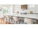 Bright kitchen island with white marble countertop, seating, and modern fixtures at 425 Harold Ne Ave, Atlanta, GA 30307