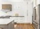 Gourmet kitchen featuring stainless steel appliances, custom cabinetry, hardwood floors, and designer finishes at 425 Harold Ne Ave, Atlanta, GA 30307